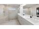 Luxurious main bathroom featuring a dual vanity, a glass-enclosed shower, and marble finishes providing a spa-like experience at 1336 Rosen Rd, Brookhaven, GA 30319