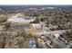 Aerial view shows proximity to athletic fields, schools, commercial buildings, and Atlanta's skyline at 1444 Norman Berry Dr, East Point, GA 30344