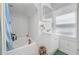An all-white bathroom features a tub/shower combo, a vanity with storage, and natural light from the window at 1444 Norman Berry Dr, East Point, GA 30344