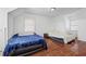 Bedroom features hardwood floors, two twin beds, and natural light from windows, creating a simple, shared space at 1444 Norman Berry Dr, East Point, GA 30344