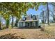 Two-story home featuring a covered front porch and a natural landscape setting at 1444 Norman Berry Dr, East Point, GA 30344