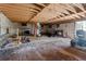 View of unfinished garage with lawn equipment and exposed ceiling at 1444 Norman Berry Dr, East Point, GA 30344