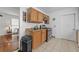 A cozy kitchen features tile flooring, wood cabinets, and essential appliances for convenient meal preparation at 1444 Norman Berry Dr, East Point, GA 30344