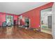 Living room featuring hardwood floors, a decorative fireplace, and access to the kitchen at 1444 Norman Berry Dr, East Point, GA 30344