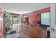 Spacious living room with hardwood floors, a large window, and built-in shelving at 1444 Norman Berry Dr, East Point, GA 30344