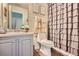 Well-lit bathroom with modern fixtures and a decorative shower curtain and cabinet at 117 Kiara Ln, Stockbridge, GA 30281