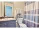 Bathroom featuring a vanity with a blue cabinet, a toilet, and a shower with a curtain at 117 Kiara Ln, Stockbridge, GA 30281