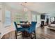 This dining room features windows for lots of natural light, hardwood floors, and seating for four at 117 Kiara Ln, Stockbridge, GA 30281