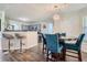 The dining area features hardwood floors, a modern chandelier, and seating for four at 117 Kiara Ln, Stockbridge, GA 30281