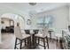 Elegant dining room with modern light fixture and view into adjacent Gathering room at 117 Kiara Ln, Stockbridge, GA 30281