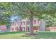 Beautiful two-story house with red shutters, complemented by a lush green lawn and mature trees at 117 Kiara Ln, Stockbridge, GA 30281
