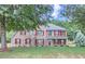 Charming two-story brick home featuring red shutters and a well-maintained front yard at 117 Kiara Ln, Stockbridge, GA 30281