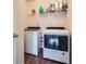 Laundry room features a washer and dryer with overhead shelving for storage at 117 Kiara Ln, Stockbridge, GA 30281
