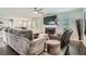 Open concept living space that features hardwood floors, a fireplace, and comfortable seating at 117 Kiara Ln, Stockbridge, GA 30281