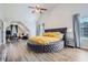 Spacious bedroom with hardwood floors, vaulted ceiling, natural light, a round bed, and ample closet space at 117 Kiara Ln, Stockbridge, GA 30281