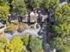 An aerial view shows the property nestled among trees with ample parking spaces and manicured landscaping at 30 Dunwoody Springs Dr, Atlanta, GA 30328
