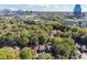 Aerial view of neighborhood surrounded by lush greenery, with city skyline at 30 Dunwoody Springs Dr, Atlanta, GA 30328