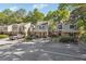 Townhome boasts a lovely exterior, neatly maintained landscaping, and convenient parking spaces at 30 Dunwoody Springs Dr, Atlanta, GA 30328