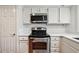 Stainless steel oven and cooktop with white countertops and cabinets at 30 Dunwoody Springs Dr, Atlanta, GA 30328