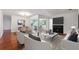 Open-concept living and dining area with fireplace, hardwood floors, and plenty of natural light at 30 Dunwoody Springs Dr, Atlanta, GA 30328