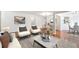 Bright living room open to dining area with modern decor and hardwood floors throughout at 30 Dunwoody Springs Dr, Atlanta, GA 30328