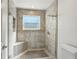 Tiled shower with glass door, bench, shower head, and hand held sprayer at 30 Dunwoody Springs Dr, Atlanta, GA 30328