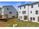 View of newly constructed townhomes featuring a well-manicured backyard with lush green grass at 3200 Bateman Dr, Atlanta, GA 30354