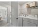 Functional laundry room with a washer, dryer, and shelving for storage and organization at 3200 Bateman Dr, Atlanta, GA 30354