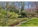 Lush backyard with mature trees, terraced gardens, and manicured landscaping, creating a peaceful oasis at 604 Ansley Villa Ne Dr, Atlanta, GA 30324