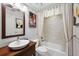 Charming bathroom featuring a wood vanity, vessel sink, and shower with curtain at 604 Ansley Villa Ne Dr, Atlanta, GA 30324