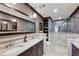 Bathroom featuring double sink vanity, tile floors, and glass enclosed shower at 604 Ansley Villa Ne Dr, Atlanta, GA 30324