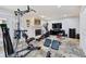 View of the home exercise room with multiple workout machines, TV, fireplace and tiled flooring at 604 Ansley Villa Ne Dr, Atlanta, GA 30324