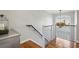 Bright hallway features modern railings, hardwood floors, and natural light from the arched window at 604 Ansley Villa Ne Dr, Atlanta, GA 30324