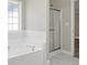 This bathroom features a bathtub, shower, and marble floors at 1088 Hubbard Sw St, Atlanta, GA 30310