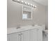 This bathroom features a double sink vanity with white cabinets, modern fixtures, and a toilet at 1088 Hubbard Sw St, Atlanta, GA 30310