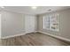 Bedroom featuring a spacious closet, hardwood floors, neutral paint, and a window for natural light at 1088 Hubbard Sw St, Atlanta, GA 30310