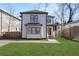Charming two-story home boasts fresh green lawn and a cheerful yellow front door at 1088 Hubbard Sw St, Atlanta, GA 30310