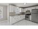 Bright kitchen features white cabinets, stainless steel appliances, and modern flooring at 1088 Hubbard Sw St, Atlanta, GA 30310
