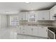 Modern kitchen with white cabinets, sleek countertops, and stainless steel appliances at 1088 Hubbard Sw St, Atlanta, GA 30310