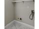 Bright laundry room featuring white tile floor and open shelving at 1088 Hubbard Sw St, Atlanta, GA 30310