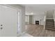 Inviting living room features a fireplace, wood floors, and staircase at 1088 Hubbard Sw St, Atlanta, GA 30310
