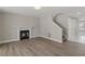 Spacious living room with fireplace, wood floors and staircase to upper level at 1088 Hubbard Sw St, Atlanta, GA 30310