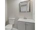 This powder room includes a decorative framed mirror, a vessel sink with cabinet, and a toilet at 1088 Hubbard Sw St, Atlanta, GA 30310