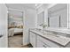 Well-lit bathroom vanity with granite countertops and access to the adjacent bedroom at 1590 Sungrown Way, Mcdonough, GA 30253