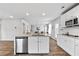 Modern kitchen featuring a spacious island, stainless steel appliances, and white cabinetry at 1590 Sungrown Way, Mcdonough, GA 30253