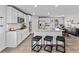 Modern kitchen with stainless appliances, granite counters, white cabinets, and island with barstool seating at 1590 Sungrown Way, Mcdonough, GA 30253