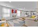 Open-concept living and kitchen area with modern fireplace, large windows, and a comfortable sectional sofa at 1590 Sungrown Way, Mcdonough, GA 30253