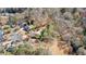 A bird's-eye view of a residential area, with houses surrounded by an abundance of trees and natural landscapes at 6715 Brookline Ct, Cumming, GA 30040