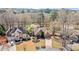 Aerial view of a beautiful home with a well-maintained lawn, mature trees, and a circular driveway at 6715 Brookline Ct, Cumming, GA 30040