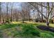 Spacious backyard with lush greenery and mature trees, offering a serene and private outdoor experience at 6715 Brookline Ct, Cumming, GA 30040